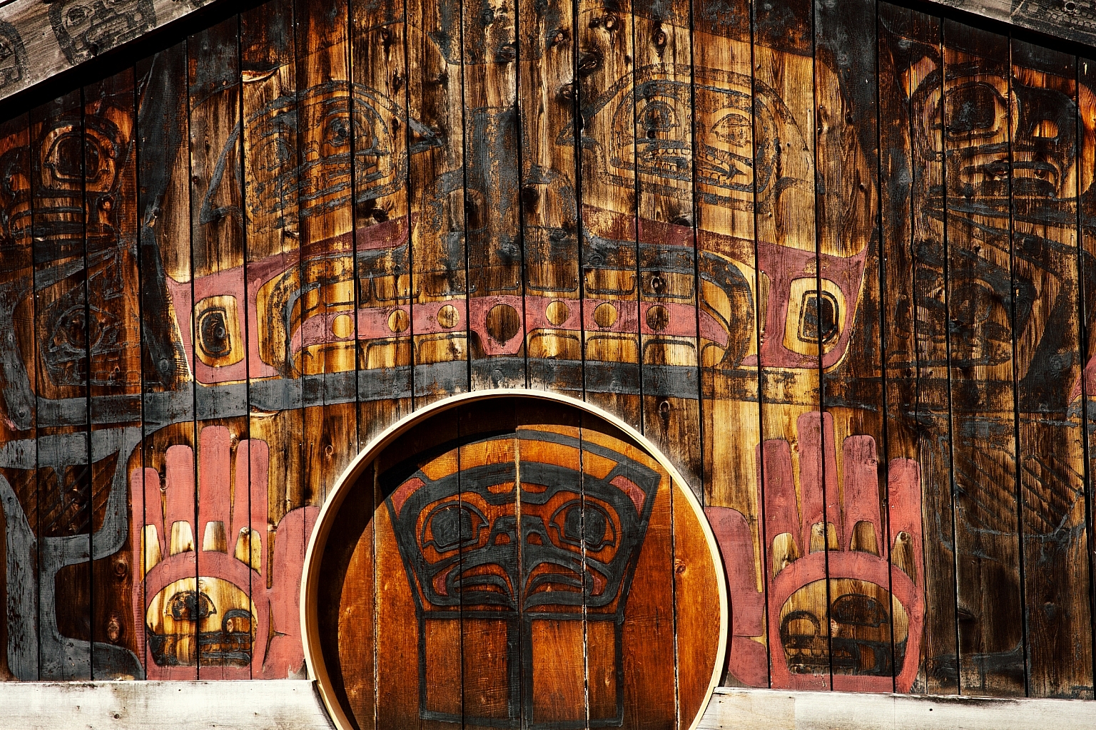 The Gitlaxt'aamiks Interpretive Centre is a large long house with striking Nisga'a Nation artwork along the side and a circular door to enter.